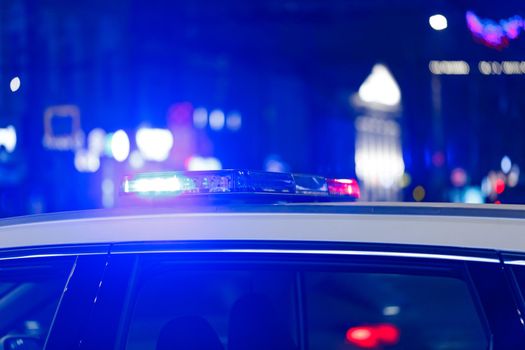 police car lights at night in city with selective focus and bokeh blur