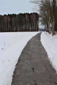 A bike and footpath in snowy rural area