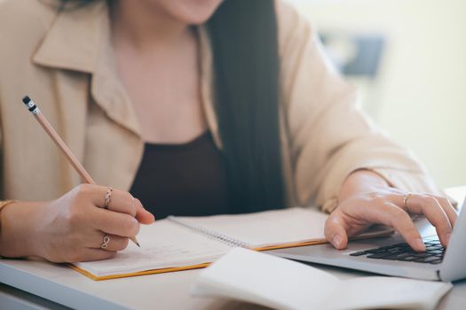 Closeup woman hands using computer laptop.