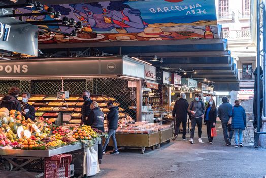 Barcelona, Spain: 2021 February 11: People in the Sant Josep La boqueria market in Winter 2021 in times of covid 19 in Barcelona