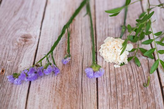 The florist desktop on light wooden background with place for text.