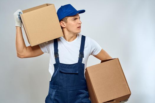 A man in a working uniform loading cardboard boxes providing services. High quality photo