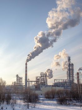 Petrochemical industrial factory of heavy industry, power refinery production with smoke pollution. Thick smoke is coming from the factory's chimney