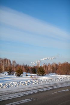 Petrochemical industrial factory of heavy industry, power refinery production with smoke pollution. Thick smoke is coming from the factory's chimney