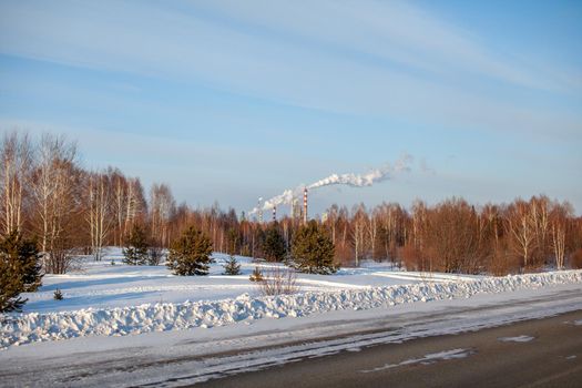 Petrochemical industrial factory of heavy industry, power refinery production with smoke pollution. Thick smoke is coming from the factory's chimney