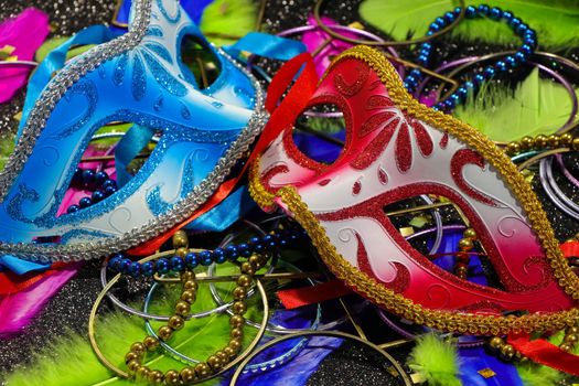 Mardi Gras red and blue carnival face masks with vibrant feathers and jewelry theme