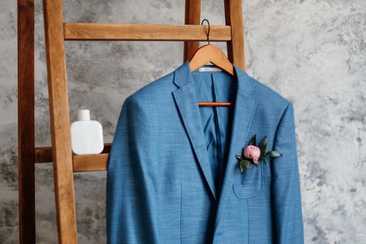 blue blazer classic suit hanging on a wooden ladder