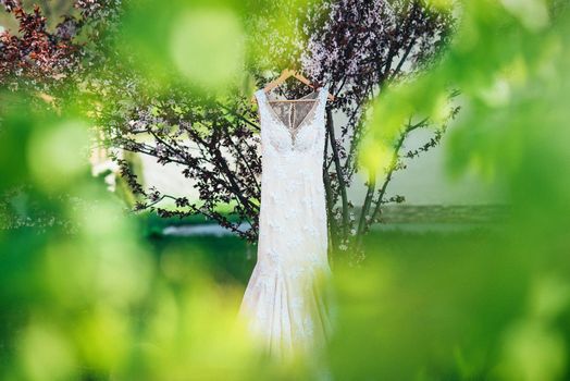 dress up the bride in a wedding dress with corset and lacing