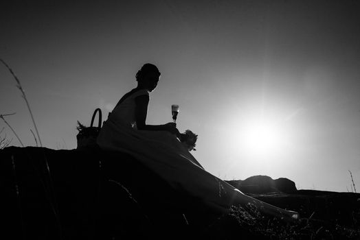 silhouettes of a happy young couple guy and girl on a background of orange sunset in the sand desert