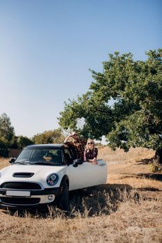 traveling by car of a young couple of a guy and a girl in plaid shirts