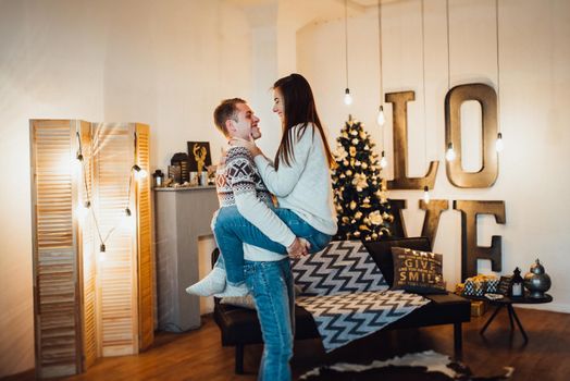 a guy and a girl celebrate the new year together
in a warm atmosphere and give each other gifts