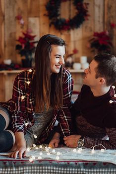 a guy and a girl celebrate the new year together
in a warm atmosphere and give each other gifts