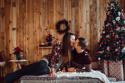 a guy and a girl celebrate the new year together
in a warm atmosphere and give each other gifts