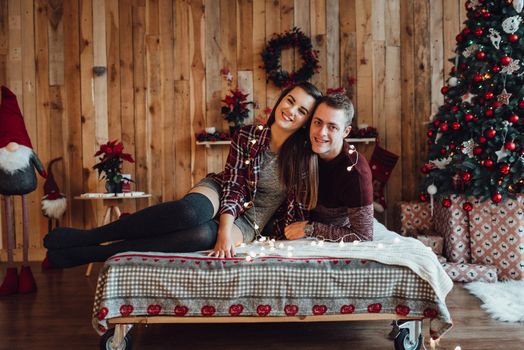 a guy and a girl celebrate the new year together
in a warm atmosphere and give each other gifts