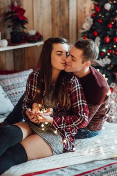 a guy and a girl celebrate the new year together
in a warm atmosphere and give each other gifts