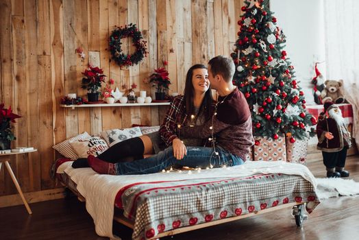 a guy and a girl celebrate the new year together
in a warm atmosphere and give each other gifts