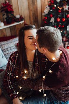 a guy and a girl celebrate the new year together
in a warm atmosphere and give each other gifts