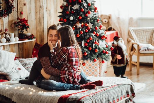 a guy and a girl celebrate the new year together
in a warm atmosphere and give each other gifts