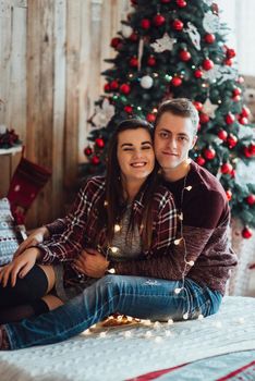 a guy and a girl celebrate the new year together
in a warm atmosphere and give each other gifts