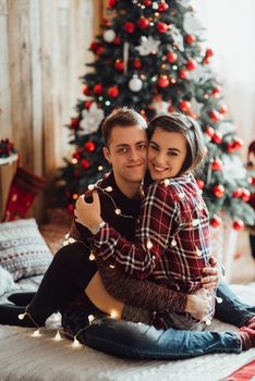 a guy and a girl celebrate the new year together
in a warm atmosphere and give each other gifts