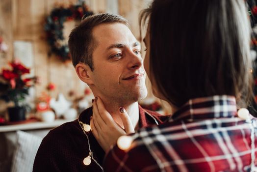 a guy and a girl celebrate the new year together
in a warm atmosphere and give each other gifts