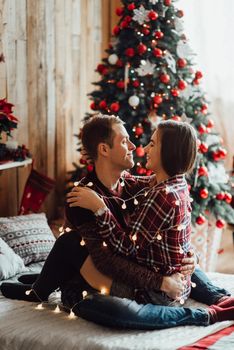 a guy and a girl celebrate the new year together
in a warm atmosphere and give each other gifts