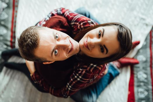 a guy and a girl celebrate the new year together
in a warm atmosphere and give each other gifts