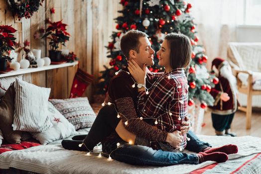 a guy and a girl celebrate the new year together
in a warm atmosphere and give each other gifts