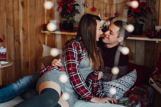 a guy and a girl celebrate the new year together
in a warm atmosphere and give each other gifts