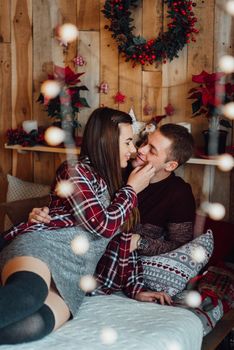 a guy and a girl celebrate the new year together
in a warm atmosphere and give each other gifts