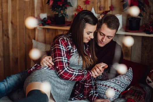 a guy and a girl celebrate the new year together
in a warm atmosphere and give each other gifts