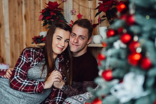 a guy and a girl celebrate the new year together
in a warm atmosphere and give each other gifts