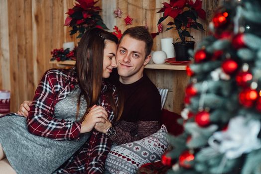 a guy and a girl celebrate the new year together
in a warm atmosphere and give each other gifts