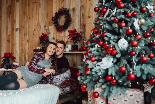 a guy and a girl celebrate the new year together
in a warm atmosphere and give each other gifts