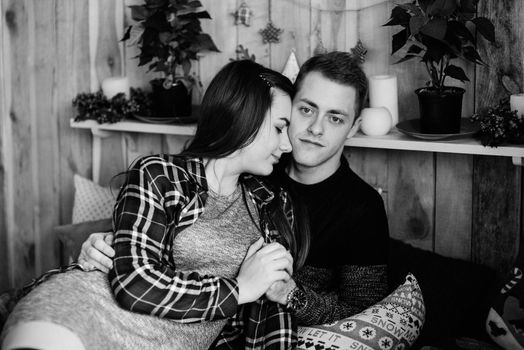 a guy and a girl celebrate the new year together
in a warm atmosphere and give each other gifts