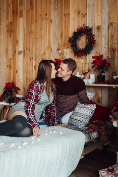 a guy and a girl celebrate the new year together
in a warm atmosphere and give each other gifts