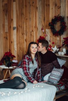 a guy and a girl celebrate the new year together
in a warm atmosphere and give each other gifts