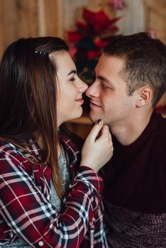 a guy and a girl celebrate the new year together
in a warm atmosphere and give each other gifts