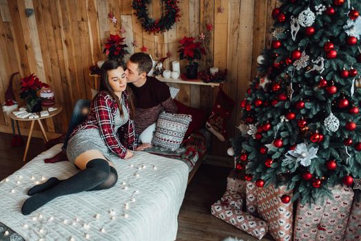 a guy and a girl celebrate the new year together
in a warm atmosphere and give each other gifts