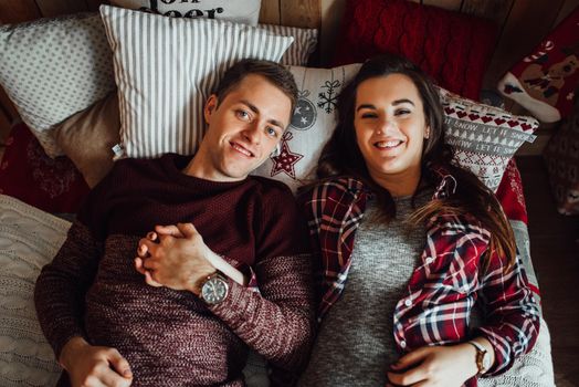 a guy and a girl celebrate the new year together
in a warm atmosphere and give each other gifts