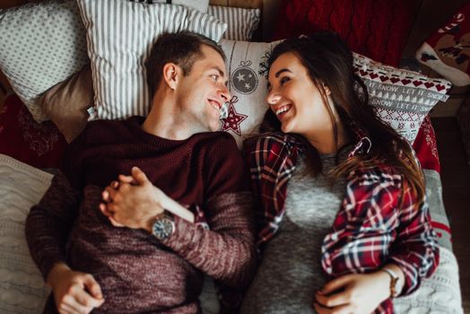 a guy and a girl celebrate the new year together
in a warm atmosphere and give each other gifts