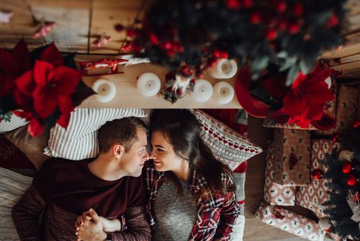 a guy and a girl celebrate the new year together
in a warm atmosphere and give each other gifts