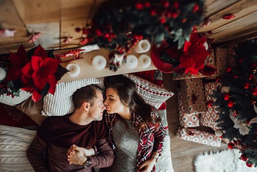 a guy and a girl celebrate the new year together
in a warm atmosphere and give each other gifts