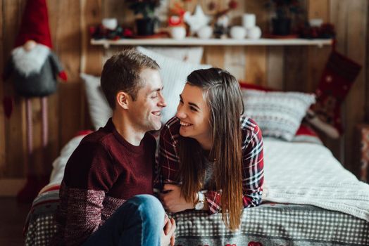 a guy and a girl celebrate the new year together
in a warm atmosphere and give each other gifts