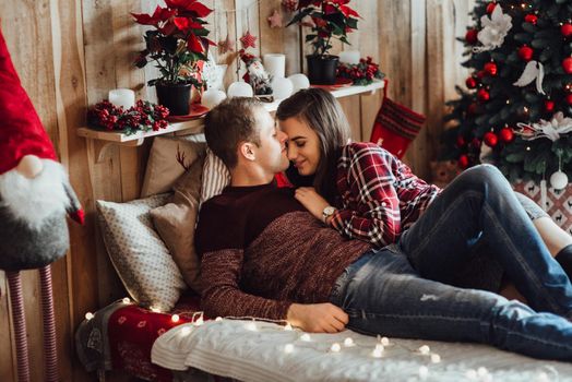 a guy and a girl celebrate the new year together
in a warm atmosphere and give each other gifts