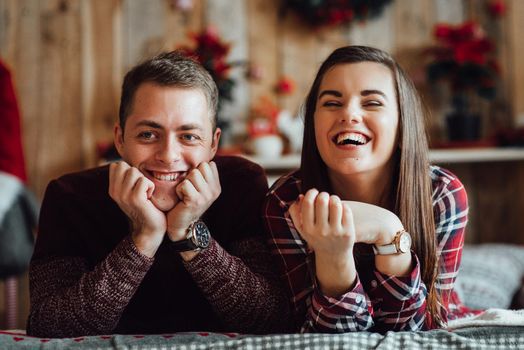 a guy and a girl celebrate the new year together
in a warm atmosphere and give each other gifts