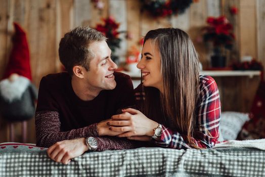 a guy and a girl celebrate the new year together
in a warm atmosphere and give each other gifts