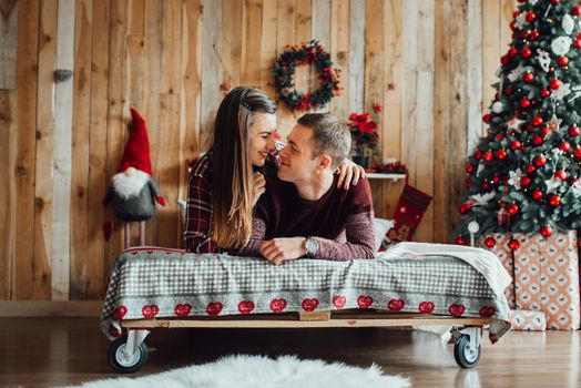 a guy and a girl celebrate the new year together
in a warm atmosphere and give each other gifts