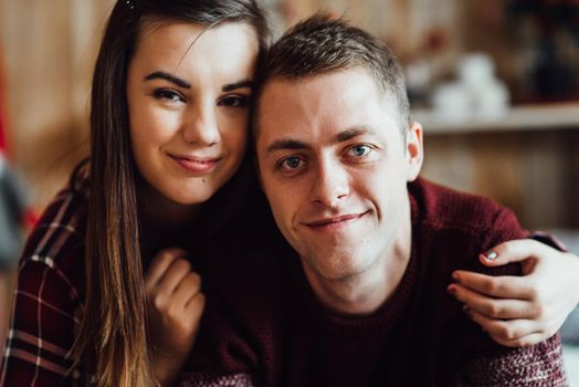 a guy and a girl celebrate the new year together
in a warm atmosphere and give each other gifts