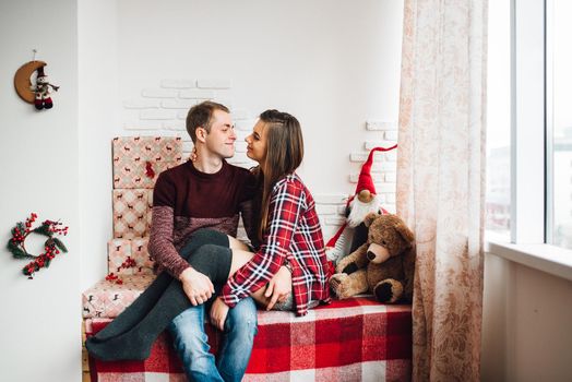 a guy and a girl celebrate the new year together
in a warm atmosphere and give each other gifts